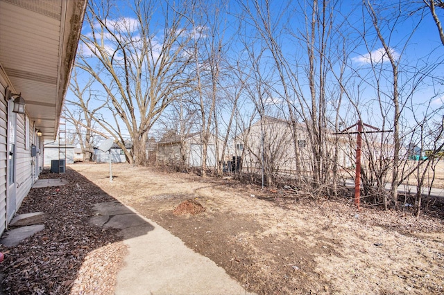 view of yard featuring cooling unit and a residential view