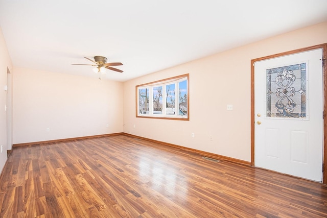 interior space with visible vents, baseboards, and wood finished floors