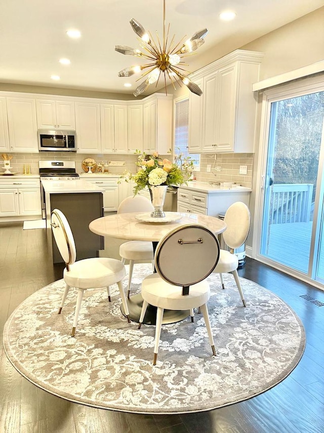 dining space featuring dark hardwood / wood-style flooring and a notable chandelier