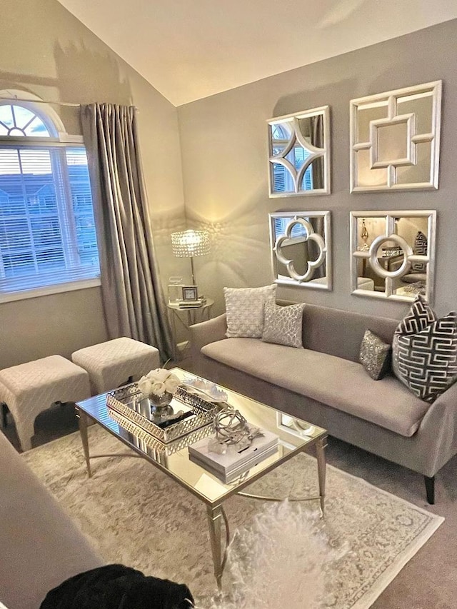 living area with vaulted ceiling and carpet floors