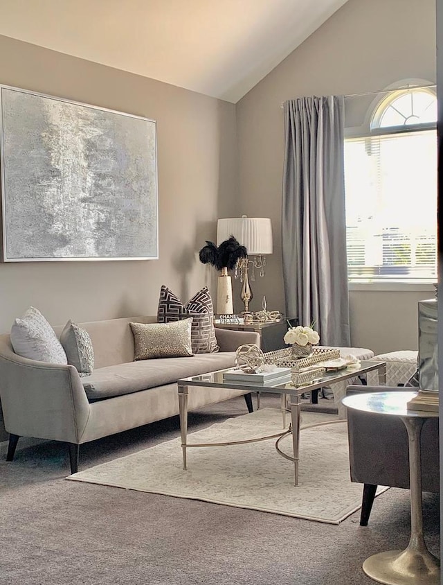 living room with lofted ceiling and carpet floors