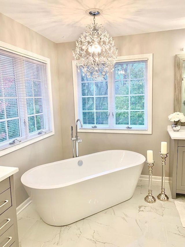 bathroom with vanity, a wealth of natural light, and a washtub