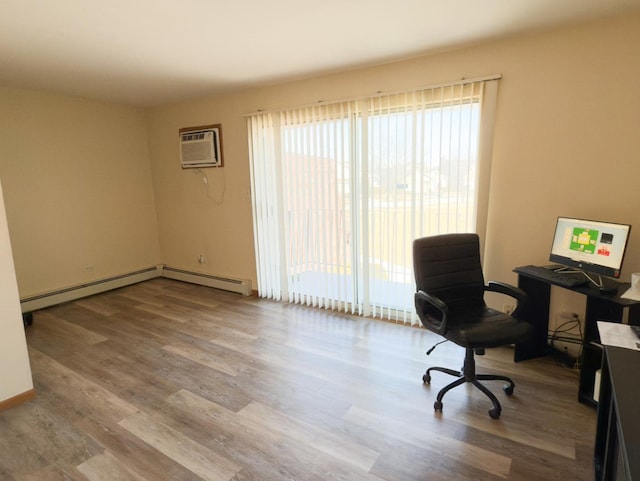 office with a baseboard heating unit, wood finished floors, and an AC wall unit