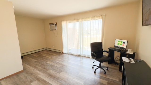 office area with baseboard heating, a wall mounted AC, and light hardwood / wood-style floors