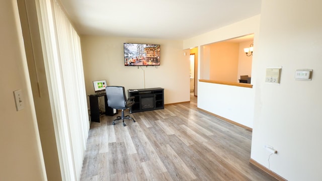 home office with light hardwood / wood-style floors