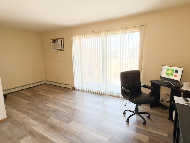 office space with baseboard heating, wood finished floors, and a wall mounted air conditioner