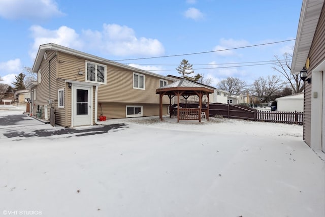 snow covered house featuring a gazebo