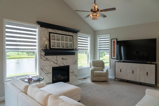 living room with light carpet, a fireplace, ceiling fan, and vaulted ceiling