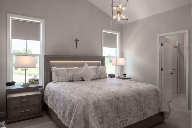 carpeted bedroom with vaulted ceiling and a notable chandelier