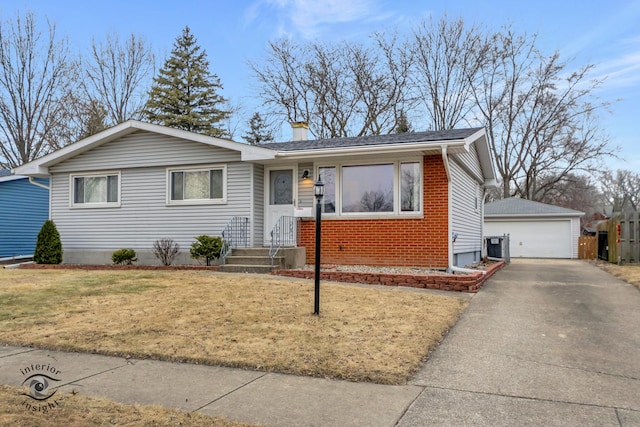 ranch-style house featuring a garage, central AC, an outbuilding, and a front yard