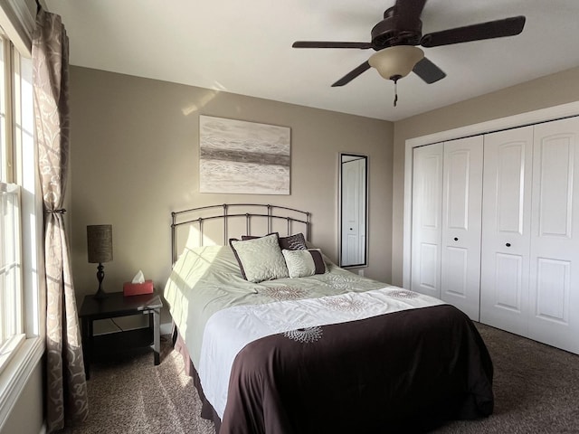 bedroom featuring dark carpet and ceiling fan