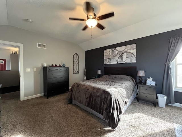 carpeted bedroom with vaulted ceiling and ceiling fan