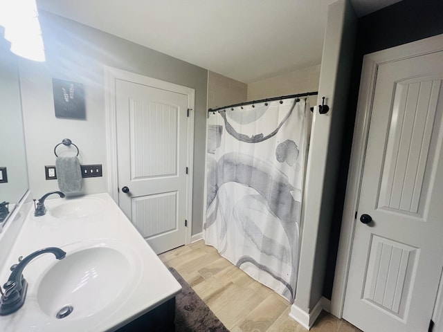 bathroom featuring hardwood / wood-style flooring, vanity, and a shower with curtain