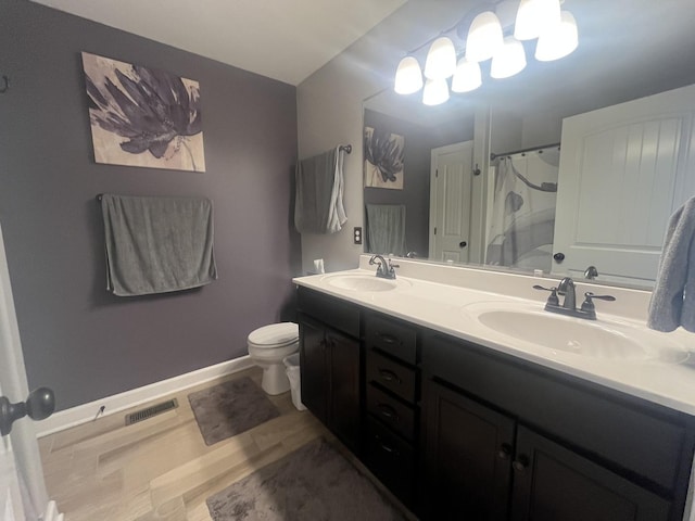 bathroom featuring vanity, toilet, and curtained shower