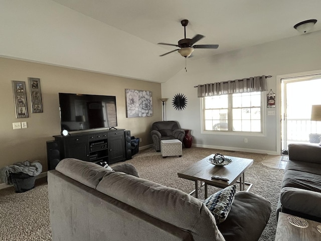 carpeted living room with ceiling fan and vaulted ceiling