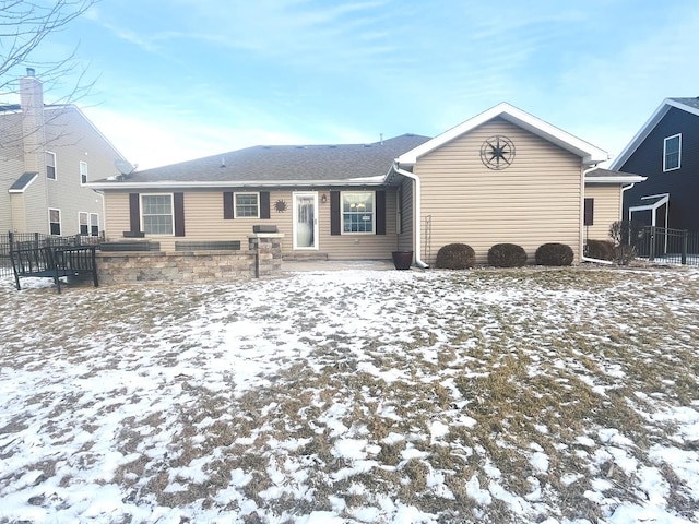 view of snow covered rear of property