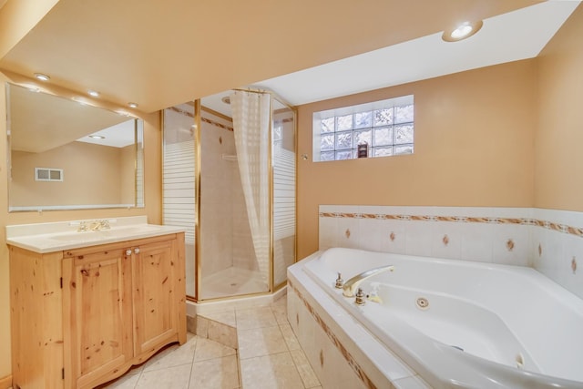 bathroom featuring tile patterned flooring, shower with separate bathtub, and vanity