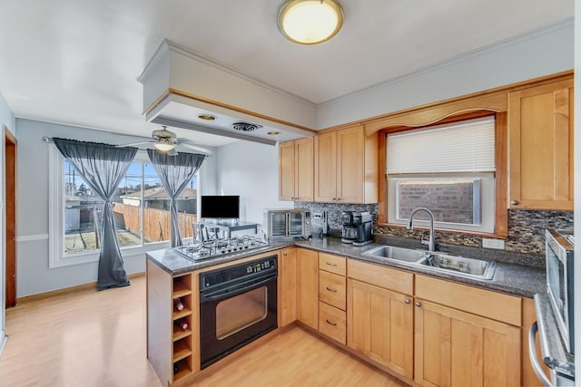 kitchen featuring stainless steel gas cooktop, sink, kitchen peninsula, oven, and decorative backsplash