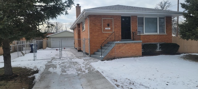 bungalow-style home with an outbuilding and a garage