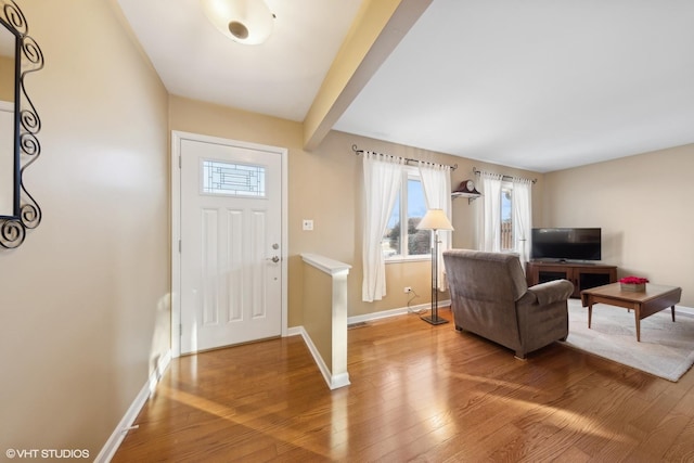 foyer featuring beam ceiling and hardwood / wood-style floors