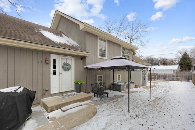 snow covered property with a gazebo