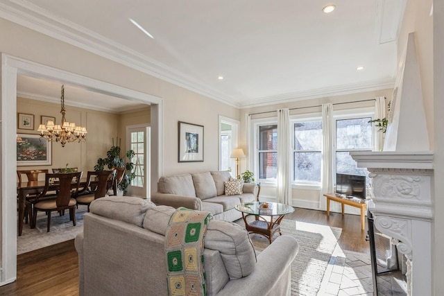 living room featuring ornamental molding, plenty of natural light, a fireplace, and wood-type flooring