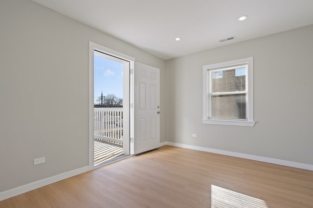 spare room featuring plenty of natural light and light wood-type flooring