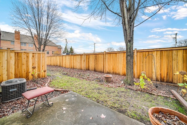 view of yard featuring central AC unit and a patio