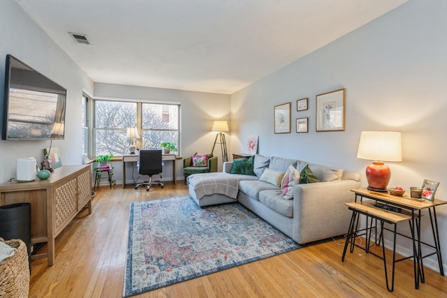 living room with light hardwood / wood-style flooring