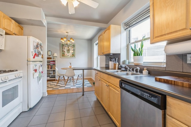 kitchen featuring sink, white appliances, decorative light fixtures, and light brown cabinets