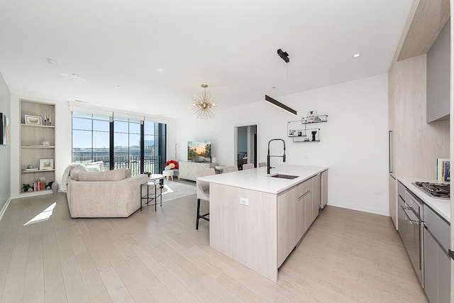 kitchen with modern cabinets, open floor plan, and light wood finished floors