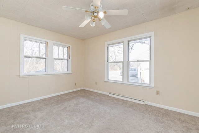 carpeted empty room with ceiling fan and a baseboard radiator