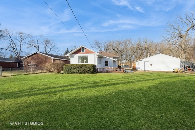 back of house with a deck and a lawn