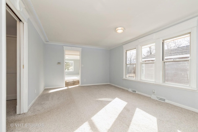 unfurnished bedroom with ornamental molding, light carpet, and a closet