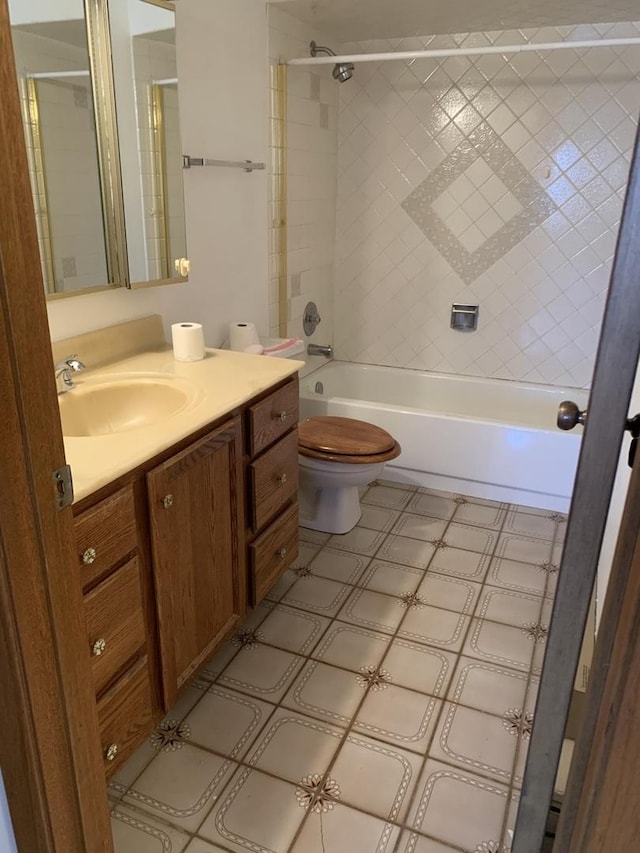 full bathroom with vanity, toilet, and tiled shower / bath combo