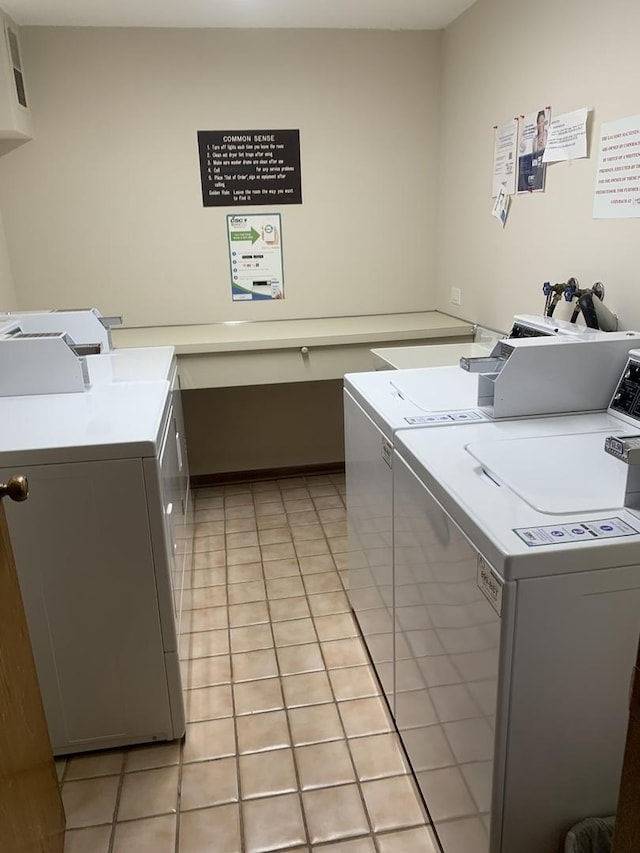 washroom with washer and dryer and light tile patterned floors