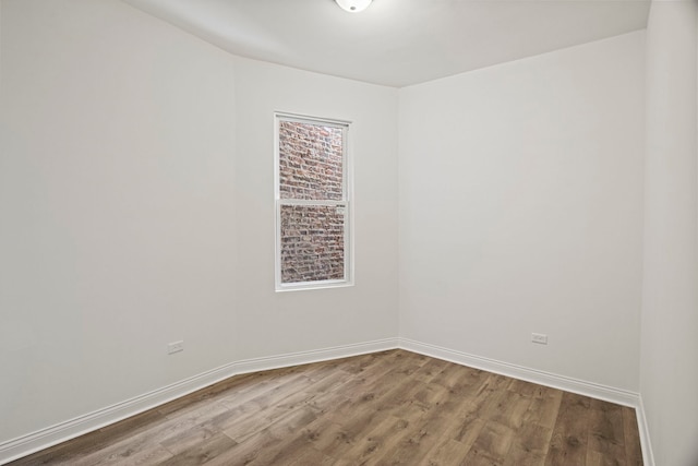 empty room with hardwood / wood-style flooring