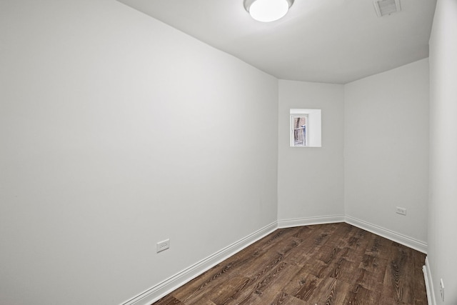 spare room with dark hardwood / wood-style floors