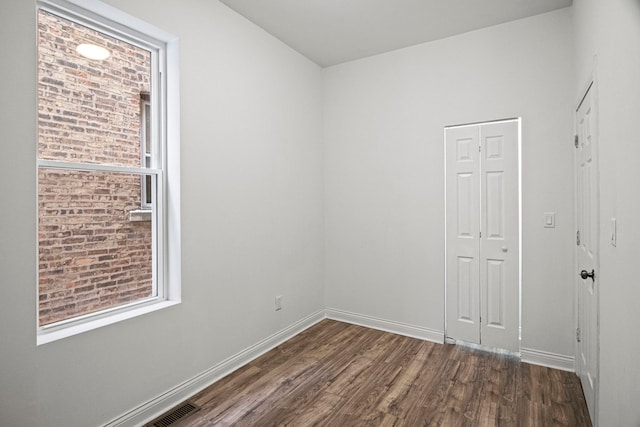 spare room featuring dark hardwood / wood-style flooring