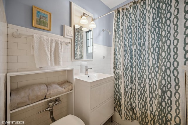 bathroom featuring vanity, tile walls, and a shower with curtain