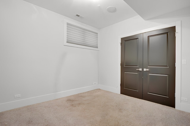 unfurnished bedroom featuring carpet and a closet