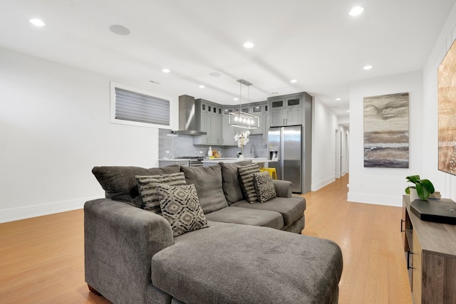 living room featuring sink and light wood-type flooring