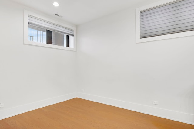 unfurnished room with hardwood / wood-style floors