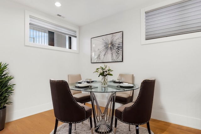 dining space with wood-type flooring