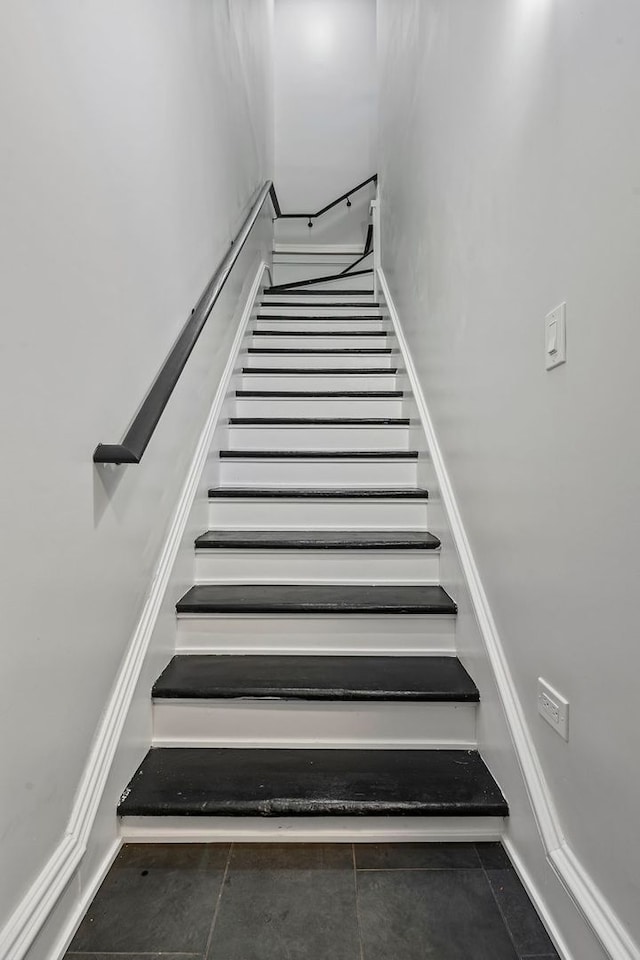 staircase featuring tile patterned flooring