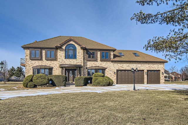 view of front of property with a garage and a front lawn