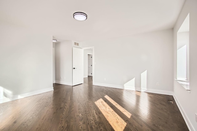 empty room with dark hardwood / wood-style floors