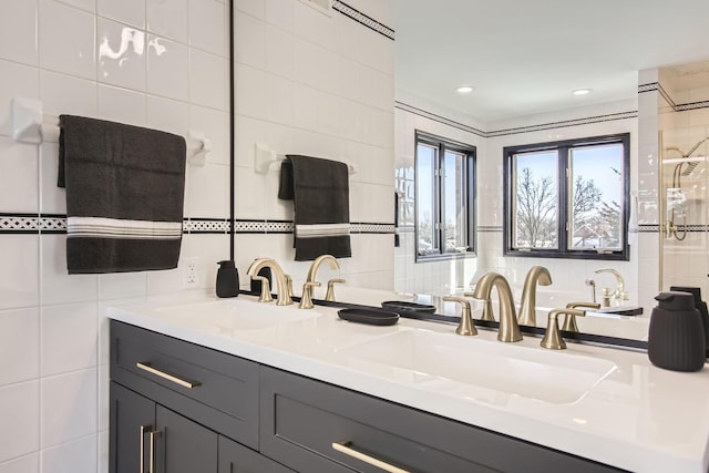 bathroom featuring vanity and tile walls