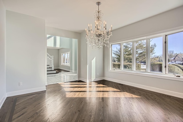 unfurnished dining area with an inviting chandelier and wood-type flooring