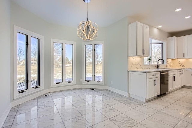 kitchen with white cabinetry, hanging light fixtures, decorative backsplash, and dishwasher